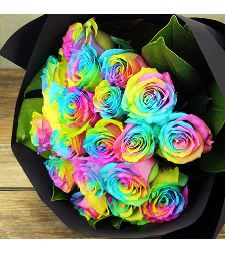 Dozen Rainbow Roses Wrapped. An arrangement by Wasaga Flowers.