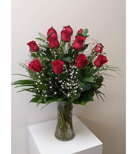 12 Red Roses arranged in a vase.