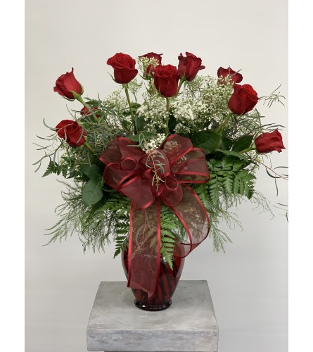 Dozen Premium Red Roses arranged in a red spring garden vase