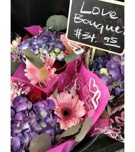 Curbside Pickup Wrapped Flower Special. An arrangement by Donato's Floral.