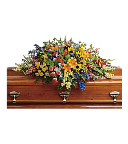 TF Colorful Reflections Casket Spray. An arrangement by Nicol Florist.