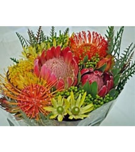 Wrapped Tropical Flower Bouquet. An arrangement by Renton Flower Shop.