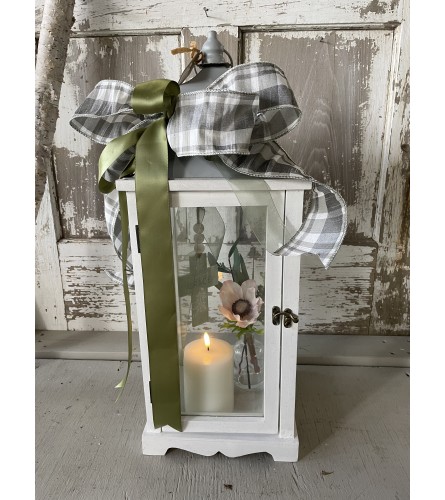White Lantern with Cross and Candle. An arrangement by Metcalfe Florist and Pleasant View Greenhouses.