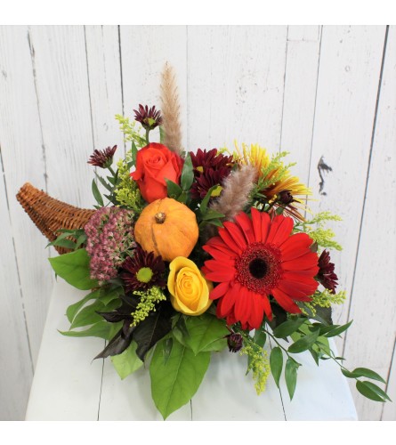 Fall Cornucopia Centerpiece. An arrangement by Avenida Flowers.