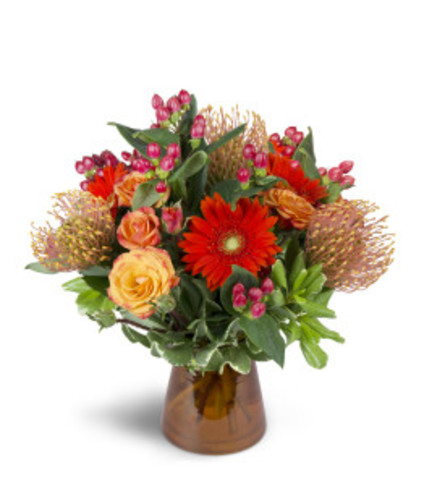 Fall arrangement in orange - Deluxe. An arrangement by Nicol Florist.