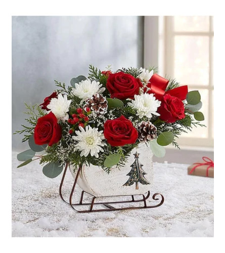 A Christmas Sleigh - Deluxe. An arrangement by Sueppel's Flowers.