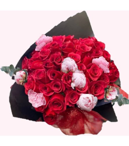 Peonies and Roses Wrapped. An arrangement by Geni's Florist and Gifts.