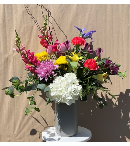 Mixed Spring flowers arranged in a ceramic vase