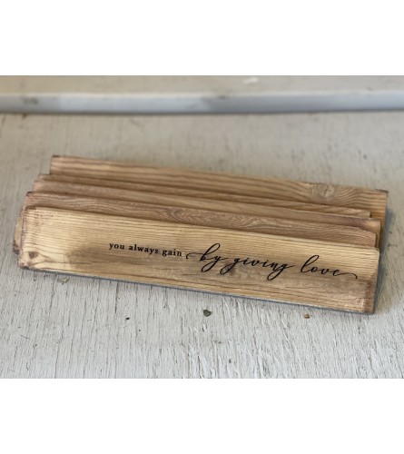 You Always Gain By Giving Love Desktop Sign. An arrangement by Metcalfe Florist and Pleasant View Greenhouses.