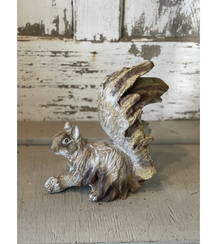 Wooden Squirrel with Acorn. An arrangement by Metcalfe Florist and Pleasant View Greenhouses.