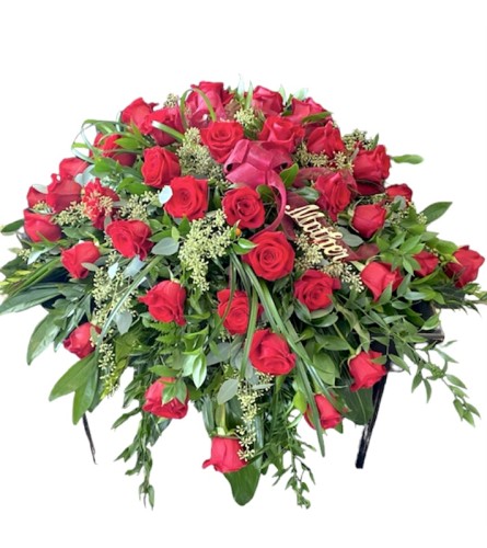 Elegance and Class Casket Spray - Deluxe. An arrangement by Loyalist Flowers.