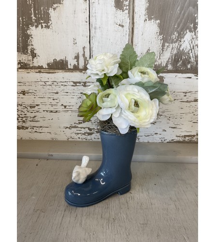 Ceremaic Blue Rainboot with Faux Flowers. An arrangement by Metcalfe Florist and Pleasant View Greenhouses.