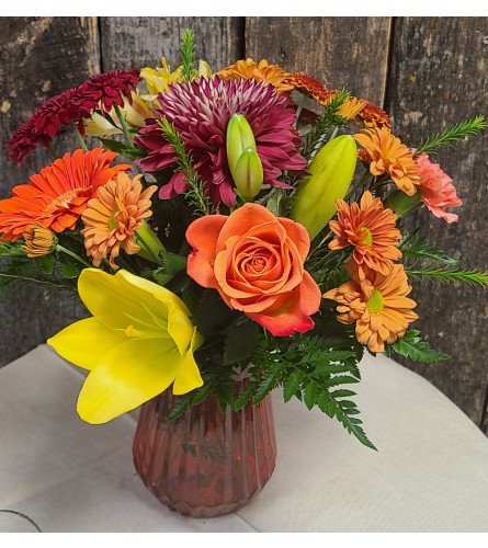Summer days and fall nights. An arrangement by Harriet's Flower and Gift Shop.