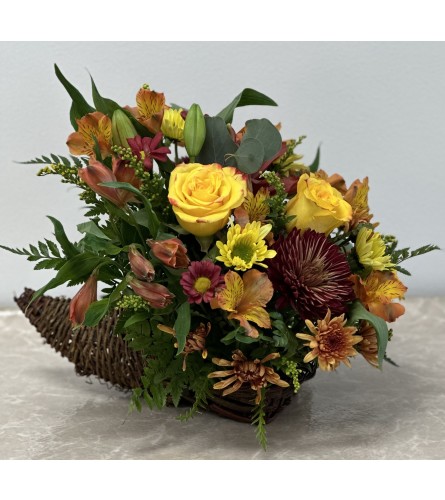 Mae's Cornucopia Blessings. An arrangement by Mae's Flowers and Gifts.