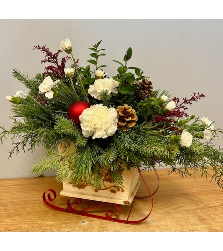 Christmas Sleigh Floral Arrangement. An arrangement by Marianna's Flower Island.