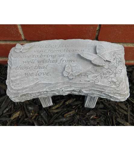 Butterflies Visit from Heaven Bench. An arrangement by North Liberty Flower Shop.