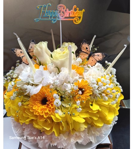 Sunshine Celebration Cake. An arrangement by Howard Beach Florist.