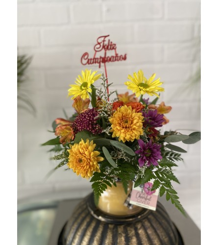 Bright Birthday Bouquet on a Candle Jar - Standard. An arrangement by The Flower Box Florist.