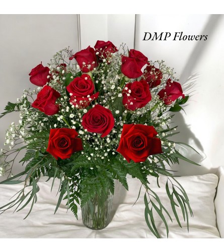 12 classic long stem roses. An arrangement by DMP Flowers and Gifts.