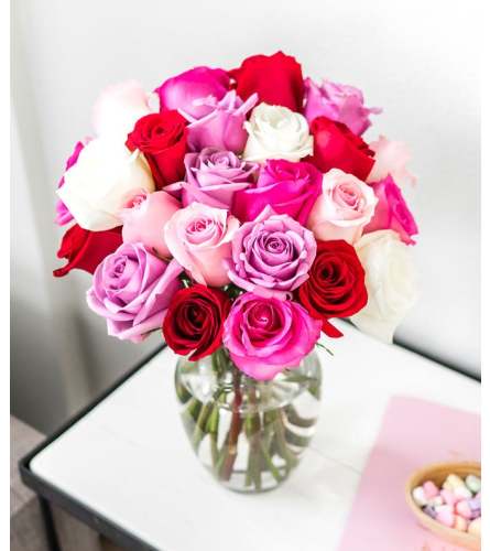 3 dozen stunning roses multi colours in a vase. An arrangement by Flowers By Gerry.