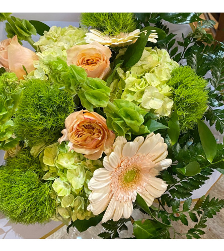 Enchanted Neutral Lovers — Wrapped Bouquet. An arrangement by Goodman's Florist.