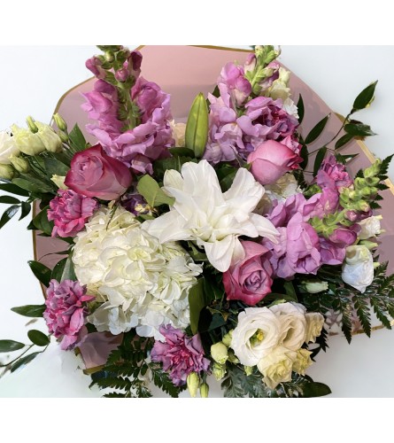 Petals of Perfection — Wrapped Bouquet. An arrangement by Goodman's Florist.