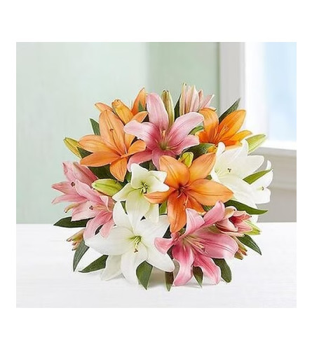 Sally's Colorful Lily Wrapped Bouquet. An arrangement by Triple A Florist.