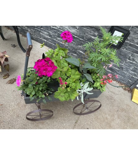 Petal Parade Wagon. An arrangement by Country Floral's Seasons, LLC.