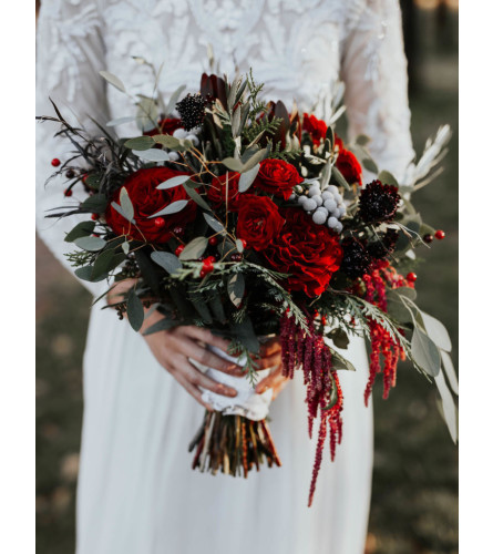 Wedding in rustic reds and winter feel bridal bouquet. An arrangement by Timp Valley Floral.