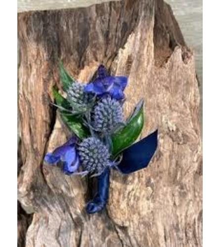 Wedding or prom blue delphinium and thistle boutonniere. An arrangement by Timp Valley Floral.