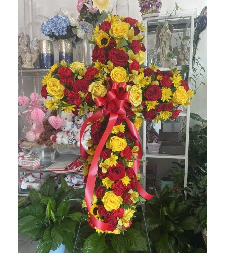 Red and Yellow Standing Cross Tribute - Deluxe. An arrangement by Sonia's Florist.