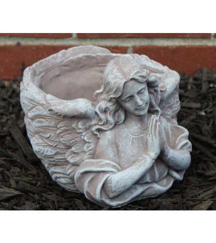 Statue - Potted Angel Bust. An arrangement by Tom Rodgers Flowers.