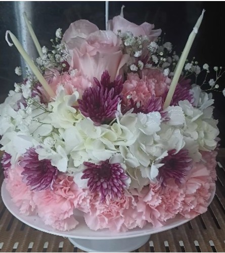 Whispering Bloom Cake. An arrangement by Howard Beach Florist.