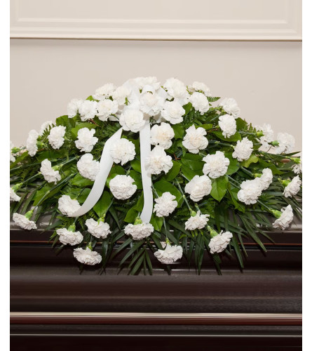 White Carnations Casket Spray. An arrangement by Flowers and Beyond.