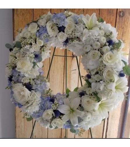 SOFT LIGTH BLUE WREATH - Deluxe. An arrangement by Geni's Florist and Gifts.