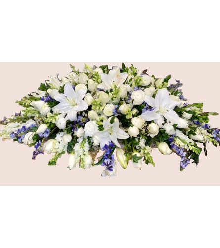 Heavenly Grace Casket Spray - Deluxe. An arrangement by Geni's Florist and Gifts.