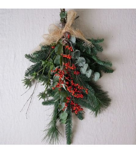 Winter Door Swag (Assorted Themes). An arrangement by Osborne Florist.