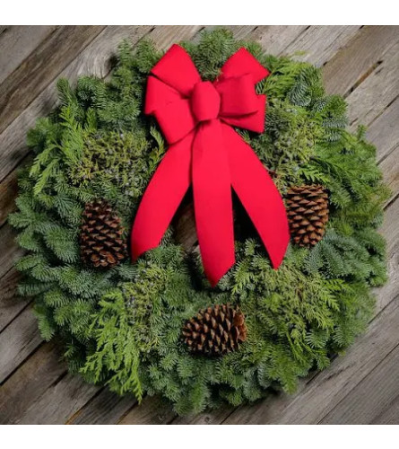 Fresh Christmas Wreath with Festive Holiday Bow. An arrangement by Sueppel's Flowers.