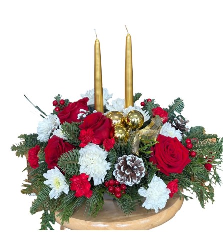 Classic Christmas centerpiece with candles. An arrangement by Azi Flowers.