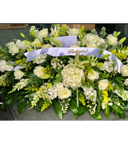 Beloved White Garden Casket Spray - Deluxe. An arrangement by Tom's Florist.