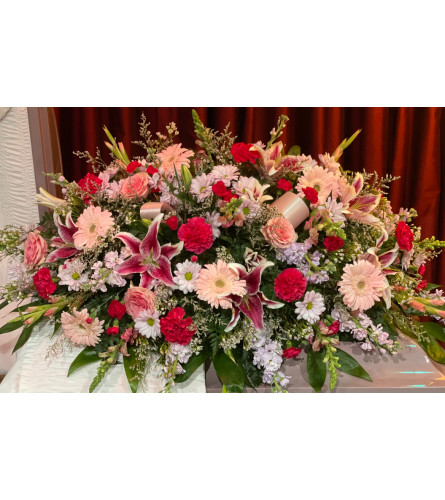 Pink and Crimson Remembrance Casket Spray - Deluxe. An arrangement by Tom's Florist.