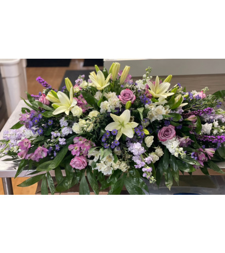 Garden Serenity Casket Spray - Deluxe. An arrangement by Tom's Florist.