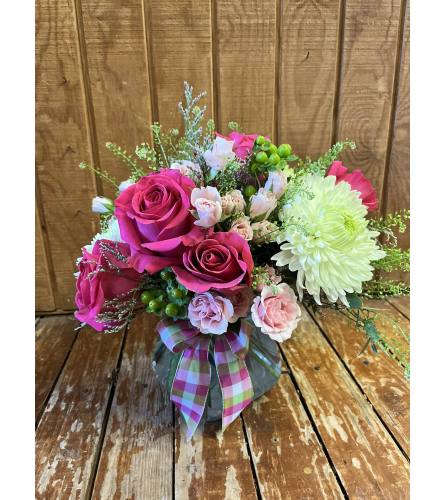 PRETTY IN PINK - ASSORTED ROSES IN LOW VASE. An arrangement by Flowers by Priscilla.