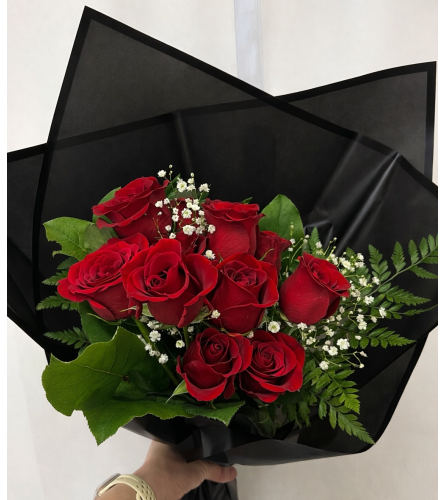 Romantic Red Roses Wrapped in Black. An arrangement by Avenida Flowers.
