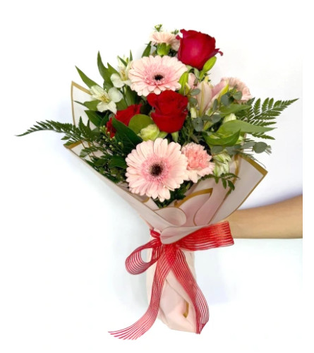 BLUSHING ENDEARMENT WRAPPED BOUQUET. An arrangement by Delray Beach Flower Market.