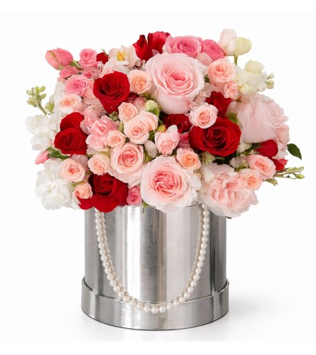 Blush and Crimson Embrace - Deluxe. An arrangement by Geni's Florist and Gifts.