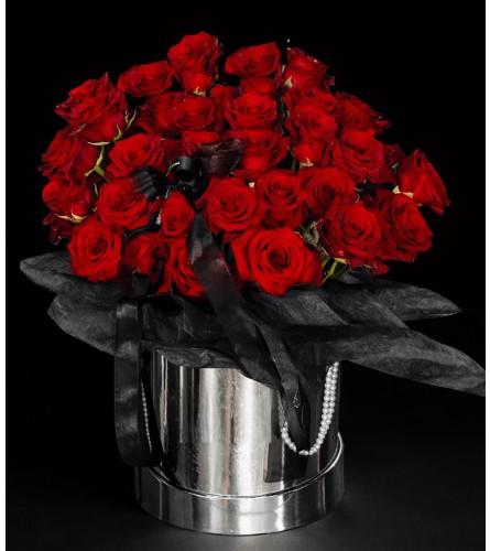 Rich Red Roses Treasure - Deluxe. An arrangement by Geni's Florist and Gifts.