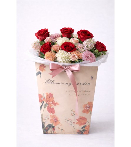 Romance to Go - Deluxe. An arrangement by Geni's Florist and Gifts.