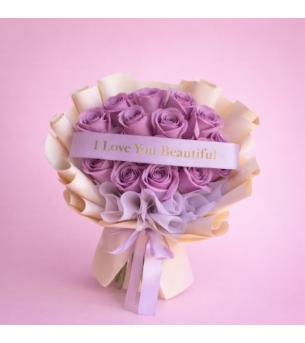 Lavender Roses Wrap - Deluxe. An arrangement by Geni's Florist and Gifts.