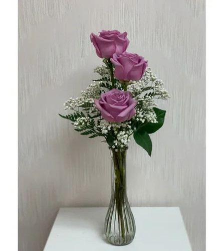 THREE PURPLE ROSES IN A VASE. An arrangement by Flowers by Priscilla.